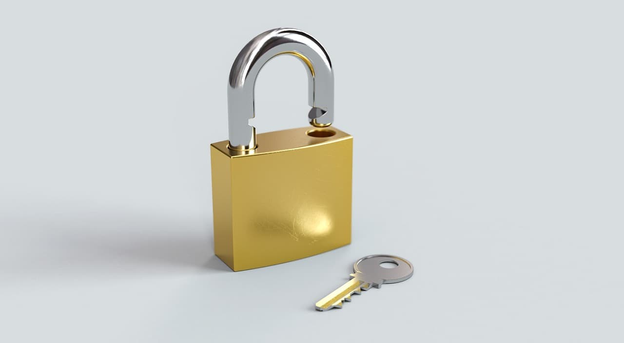 A golden padlock standing next to its key on a plain background - with standard pCloud storage the provider holds the key; the Crypto add-on hands the key to you alone.