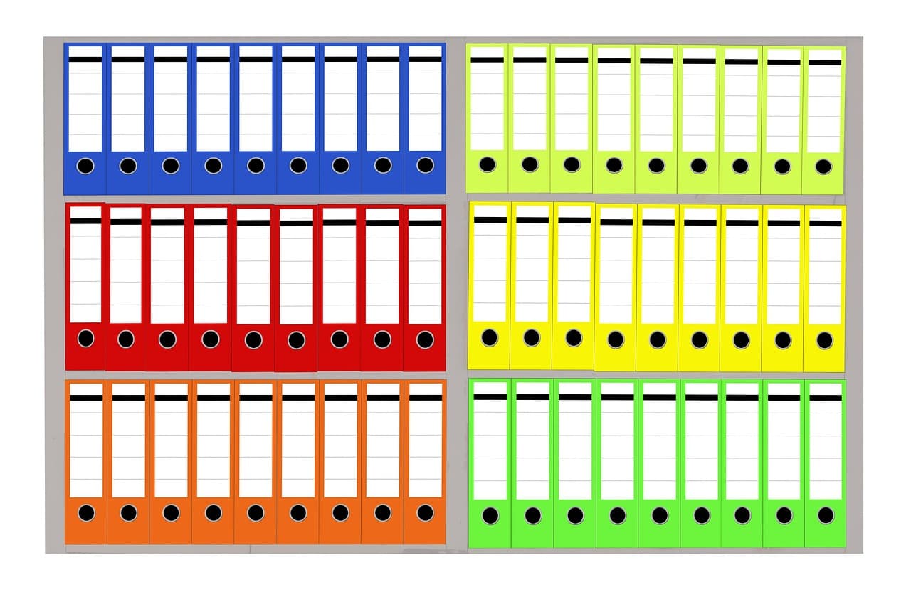A row of labelled office folders in a filing cabinet