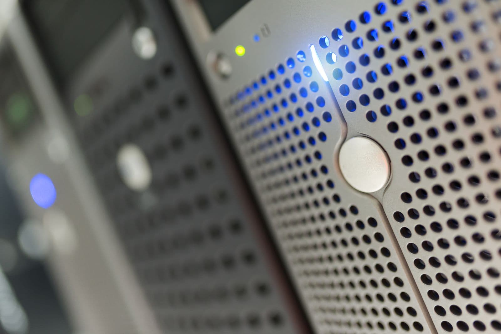 A modern server rack with blue LED indicators in a data center